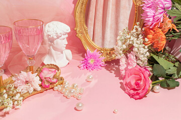 Spring summer creative layout with David head statue, vintage golden frame mirror, pink wine...