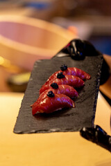 japanese food otoro sushi on black plate with hand