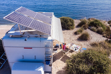 Caravan with tilt solar panels on roof. Aerial view. - obrazy, fototapety, plakaty