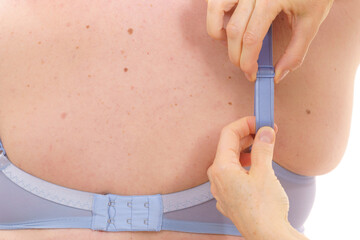 Bra fitter help plus size woman find perfect fit. Back view.