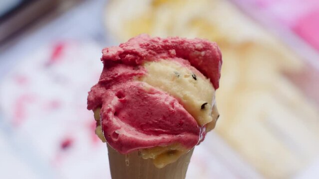 Homemade Ice Cream Close Up. Pink and yellow ice cream balls on waffle rotating in slow motion.