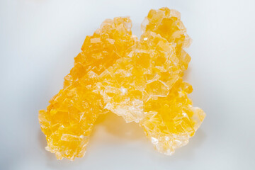 Lump sugar in crystals. Sweet dessert on a light background. Asian sweets.