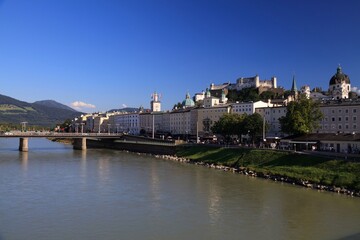 Fototapeta na wymiar Salzburg, Austria. Summer city view with Hohensalzburg Fortress, other landmarks and river Salzach