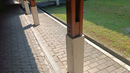 The wooden pillars serving as supports for the roof of the corridor in the garden