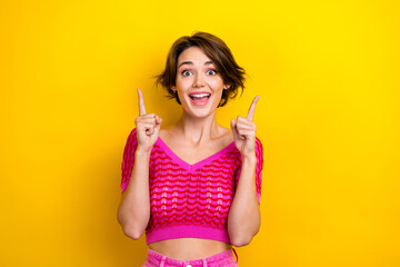 Photo of impressed overjoyed girl dressed off shoulder shirt indicating at empty space discount isolated on yellow color background