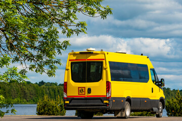 Fototapeta na wymiar Back view of a yellow school bus standing on the parking lot