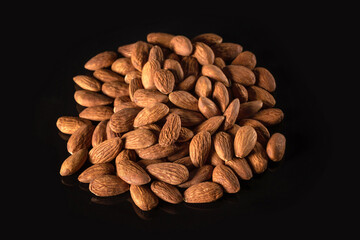 Almonds on a black background close-up. Nuts. Healthy food