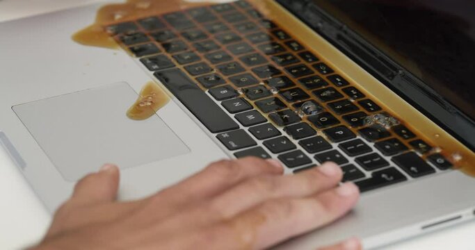 Coffee spill, keyboard and business man with mess, damage and disaster on computer in workplace. Corporate, crisis and hands of male worker with beverage accident, mistake and liquid splash on laptop