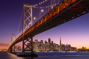 Fototapeta na wymiar San Francisco view over bridge to city skyline at sunset