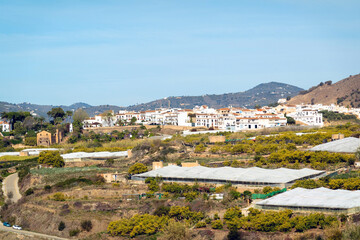 Plastic greenhouses near the white village of Maro (Nerja) on the Andalusian coast, Spain