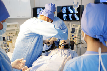 A medical team uses a defibrillator to save a patient in the emergency room.