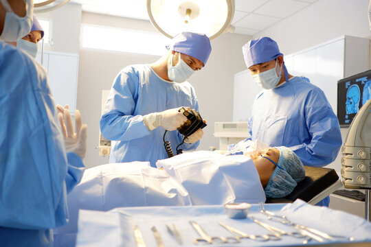 A medical team uses a defibrillator to save a patient in the emergency room.