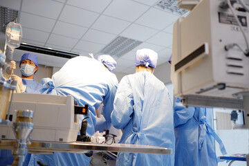 The medical team is operating on a female patient in the operating room.