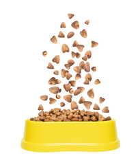 Dry food for cats or dogs falls in a yellow plastic bowl isolated on a white background