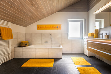 Modern european bathroom, with white bath tub and yellow accents