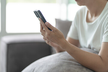 Woman hand using smartphone for checking social media or  woman reading ebook on screen.