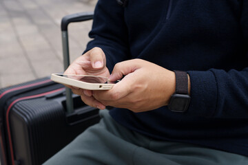 Man in downtown city street ordering taxi using smart phone app Booking taxi using application online on smart phone