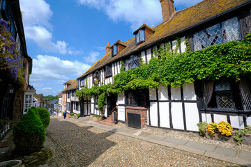 Rye, East Sussex, England, Europe - May 18, 2023: The Mermaid - ancient hotel on a cobblestoned street. A small English medieval coastal town on a sunny day.