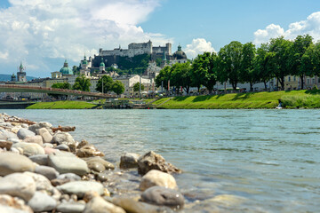 Salzach riverbank in Austria Salzburg with towers and the castle skyline of the city
