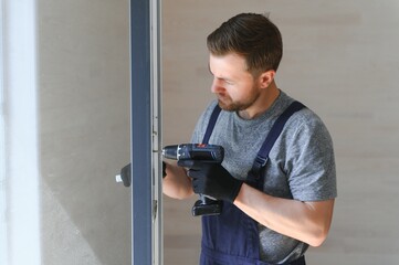 A worker installs windows in a new modular home. The concept of a new home.