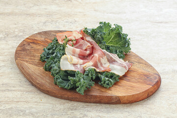 Raw pork bacon over board