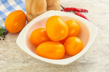 Sweet ripe yellow tomato in the bowl