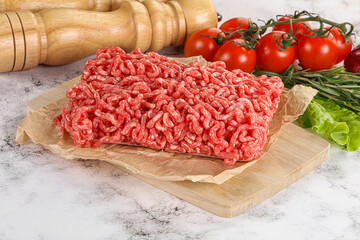 Raw minced beef meat on cutting board