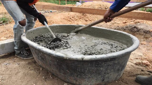The mixing of stone, cement, sand together to make a strong concrete floor