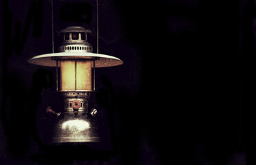 Fototapeta na wymiar old storm lantern in the dark background vintage style
