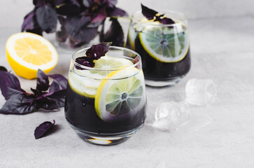 Basil Lemonade, Refreshing Summer Cocktail, Infused Water, Iced Tea, Lemon and Purple Basil Cold Drink on Bright Background