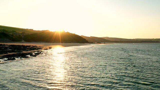 Sunrise at Bigbury Beach from over the South Devon water