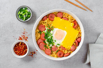 Ramen Noodles with Sausages, Egg, Melted Cheese and Scallion, Microwave Shin Ramyeon or Ramyun on Bright Background