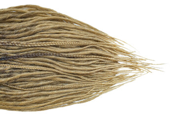 Dreadlocks are laid out on a white background and taper to the ends. Blonde braids on a white background at close range