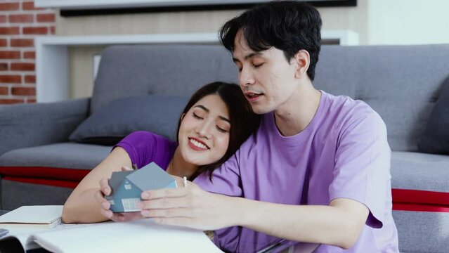 Young Asian couple planning to design a new home together