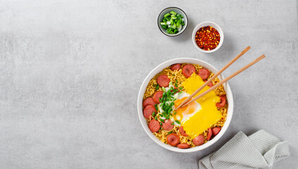 Ramen Noodles with Sausages, Egg, Melted Cheese and Scallion, Microwave Shin Ramyeon or Ramyun on Bright Background