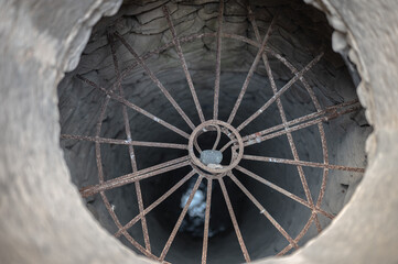 Detail of a well hole in a house, there is a grate to prevent anyone from falling