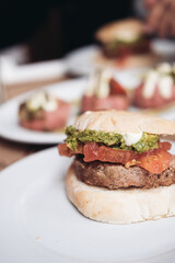 A sandwich with meat, tomatoes, avocado and mayonnaise on a plate 