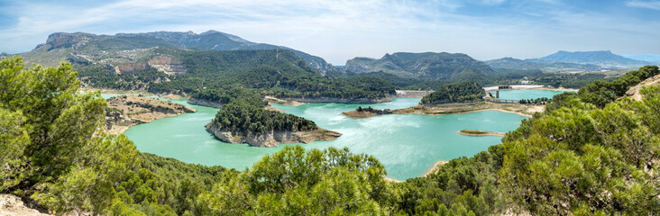 Dams in Andalucia, Southern Spain, suffering from water shortage and low water levels; seen from the Tres Embalses (three dams) viewpoint on the Guadalhorce river - obrazy, fototapety, plakaty