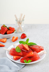 Refreshing Strawberry Popsicles, Ice Lolly with Fresh Strawberry and Mint on Bright Background