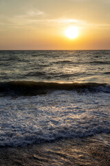 Sunset on the sea in the clouds with sun rays