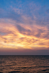 Sunset on the sea in the clouds with sun rays