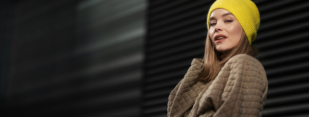 Portrait of young fashionable woman in a city.