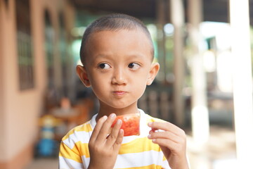 Asian boy eating delicious apples