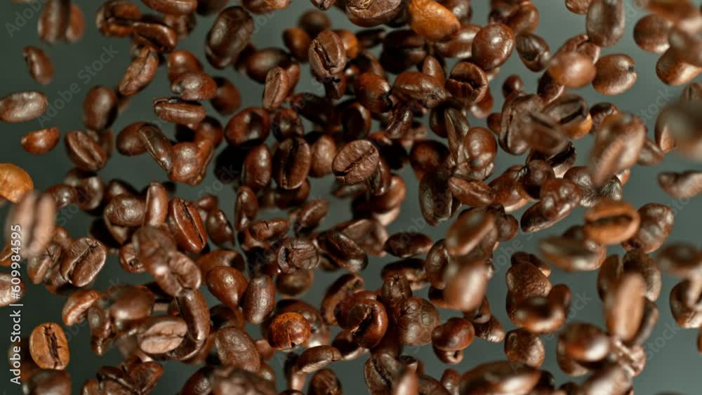 Poster Super slow motion of rotating coffee beans on black background. Filmed on high speed cinema camera, 1000 fps placed on high speed cine bot.  Camera moving up with rotation. 