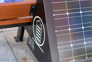 Bench with a solar panel for charging the phone. Modern technologies, alternative sources of energy. Environment concept