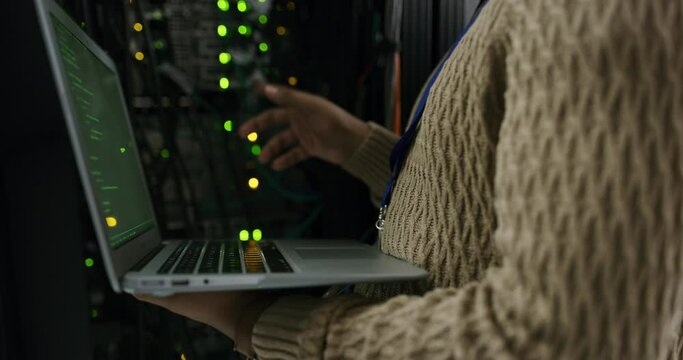 Server room, laptop and hands of technician coding or programming cyber security code or cloud computing online or on the web. Big data, database and person or programmer typing in a datacenter