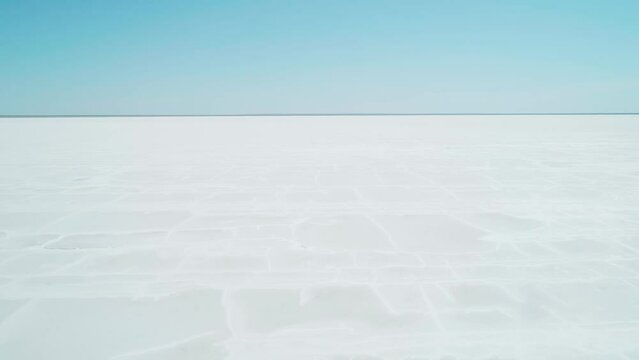 Aerial wide view of salt lake coast. Baskunchak in high tourist season at bright sunny day. Unique lake in the southwest of Russia, medicinal clay and mud deposite