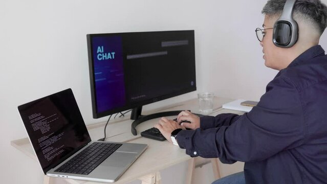 AI chatbot: Programmer using artificial intelligence for software development inside office - Virtual chat Bot technology trend - Focus on hands
