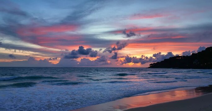 Amazing beach sunset with endless horizon..and incredible foamy waves. hills in the background..Dramatic sunset and sunrise sky..Paradise beach. Tropical paradise, white sand, beach and clear water..