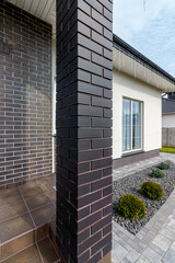 Fragment of a modern building lined with decorative bricks in the old style